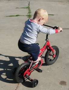 Matthias rides bike in the driveway.